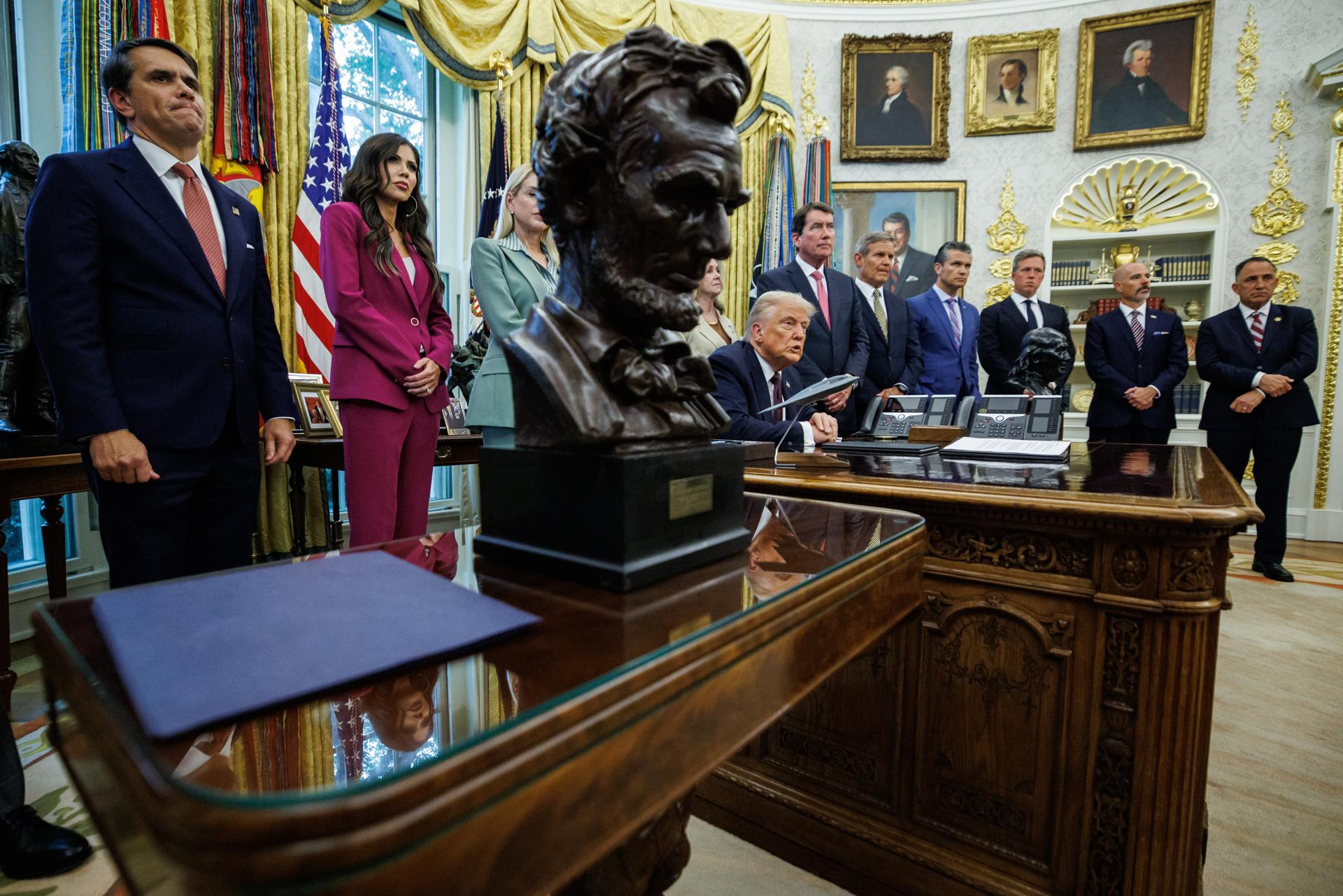US President Trump signs a Presidential Memorandum in the Oval Office